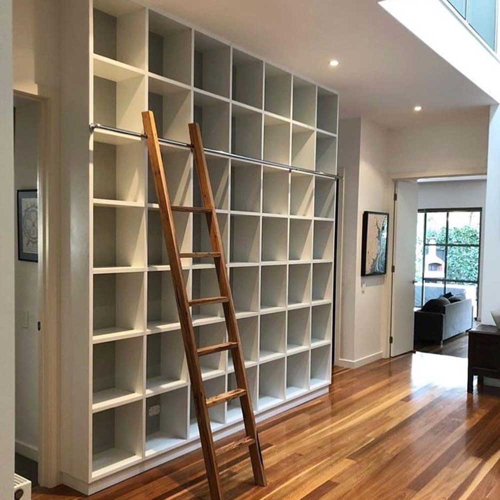 Study: Floor to ceiling white bookshelf with messmate ladder